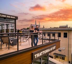 couple on a rooftop bar at sunset