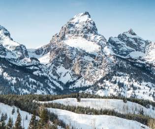 Grand Tetons with snow and blue skies
