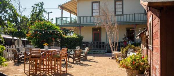 Exterior view of the patio at Big Nose Winery, tables and chairs.