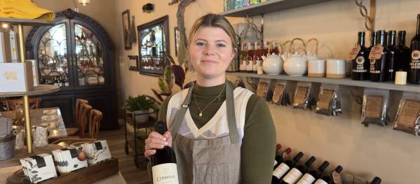 A woman holding a bottle of wine