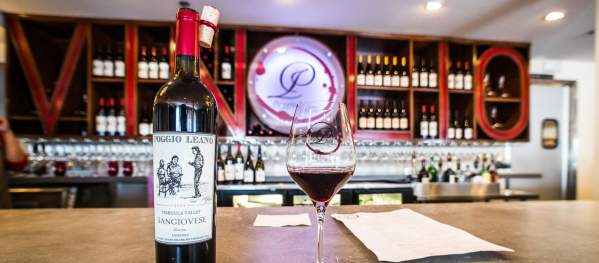 A bottle of wine and a glass