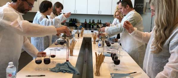 People in lab coats learning abou the science of wine