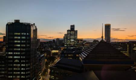A view across the Birmingham skyline from the WMGC office in The Colmore Building. 103 Colmore Row and The Octagon are visible in the sunset.