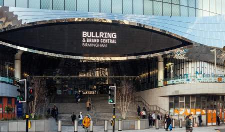 A large oval sign reads 'Bullring and Grand Central Birmingham' on the front of a mirrored building above the main entrance.