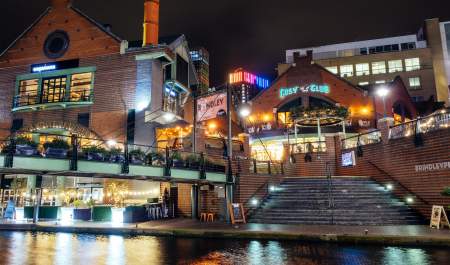 A collection of restaurants in Brindleyplace, taken at night across the water of the canal.