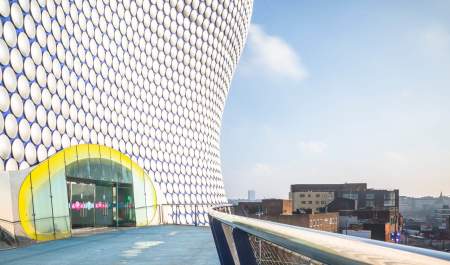 The outside doors of Selfridges in Birmingham, with the iconic circular pattern on the outside of the building.