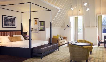 The Grand Hotel luxury suite, featuring a canopy bed, table and two chairs
