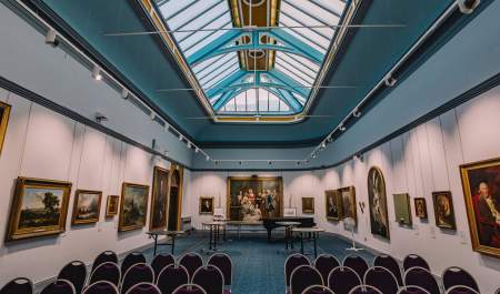 Portraits and paintings line the wall of Wolverhampton Art Gallery beneath an exquisite skylight