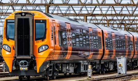 West Midlands Trains Class 196 train in orange and purple livery