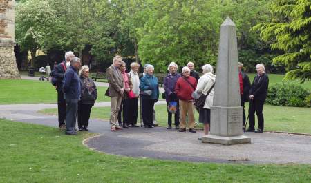 Guided tour group standing next to the Obelisk in Castle Park