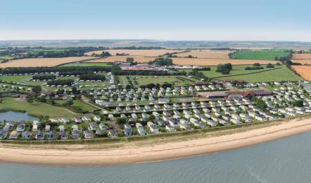 Aerial view of Waldegraves Holiday Park showing holiday homes by the beach