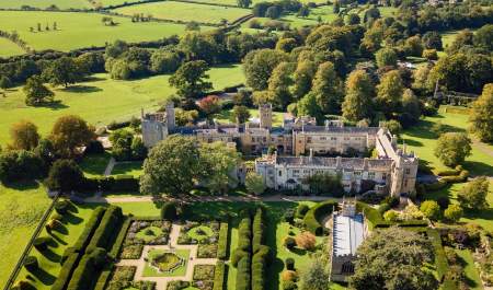 Aerial view of Sudeley Castle amongst rolling hills