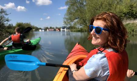A couple kayaking on the River Thames at Lechlade with Cotswold Canoe Hire