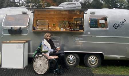 Heidi by a food van in her wheel chair