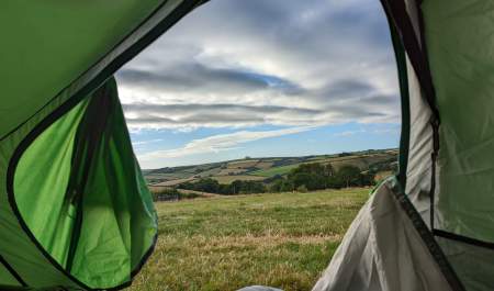 View of countryside through tent door