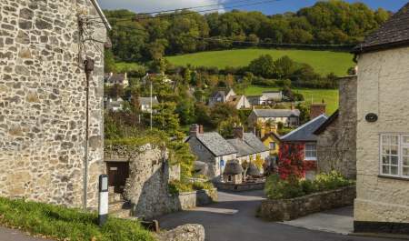 A street in Branscombe surrounded by fields and blue sky