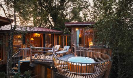 treehouse with hot tub and balcony at dusk