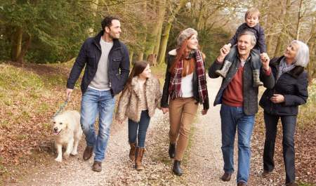 family walking a dog in autumn