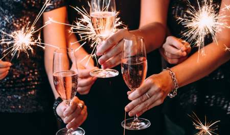 people holding glasses at new years eve