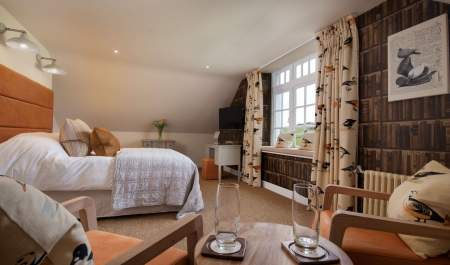 bedroom with double bed curtains and withe throw