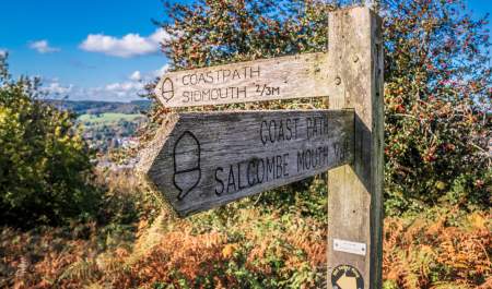 wooden sign for coast path for sidmouth and salcombe
