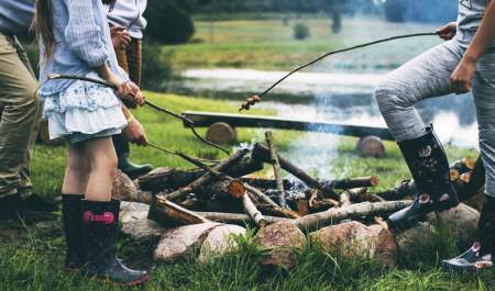 a family roasting marshmallows over a fire