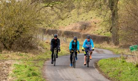 Group cycling along a country road near Thixendale