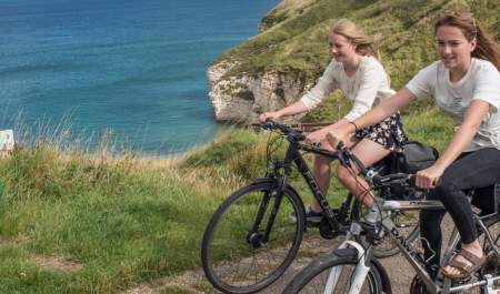 Girls cycling along the cliffs at Flamborough