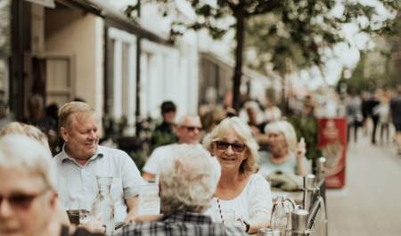 Happy people at an outdoor café in the pedestrian street in Sarpsborg.