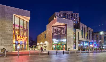 The cultural quarter at night showing John Hansard Gallery and Mayflower Studios buildings with signage lit up