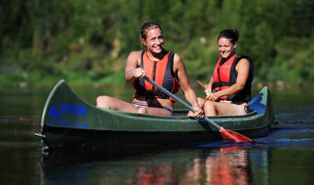 Two girls canoeing on the river