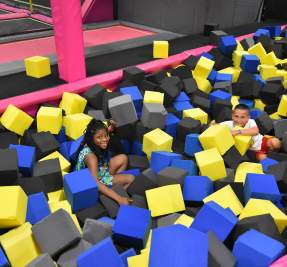 boy and girl playing in large foam blocks