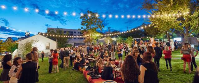 twilight at fair market outdoor event venue with people and twinkle lights in austin texas
