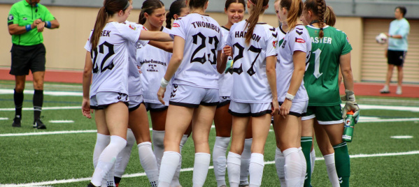 A group of FC Milwaukee Torrent players huddled in conversation during a match