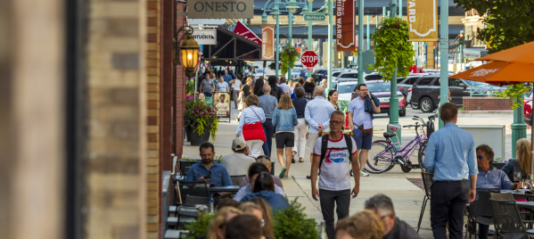 crowds walk through the historic third ward on a summery day.