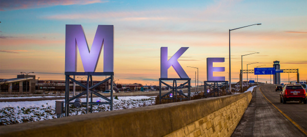 big MKE letters by airport, sunrise