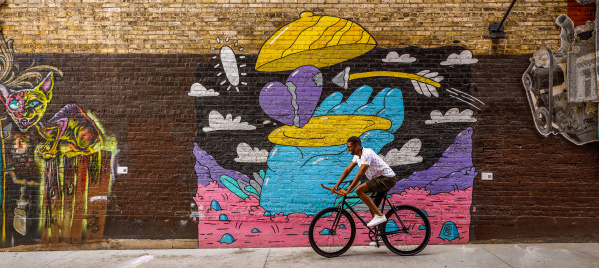 man biking through Black Cat Alley