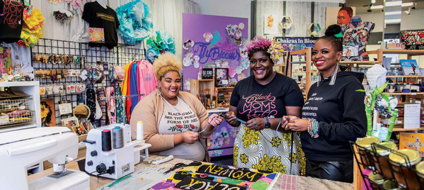 three women smiling in a store