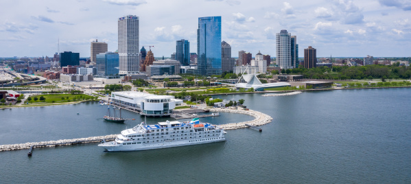 drone shot of the Pearl of the Mist Cruiseline in front of the Milwaukee skyline
