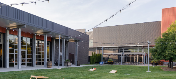 cornhole set up in the grass outside of Harley-Davidson Museum's the Garage