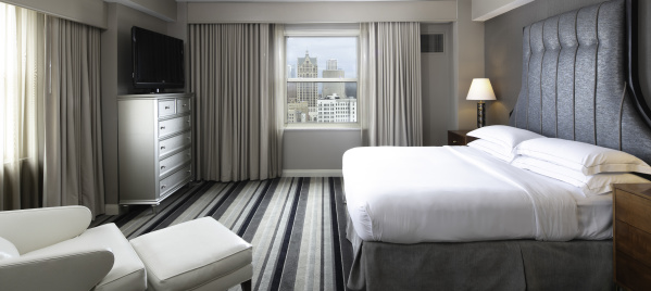 interior of a hotel room with Milwaukee Skyline prominent outside the window
