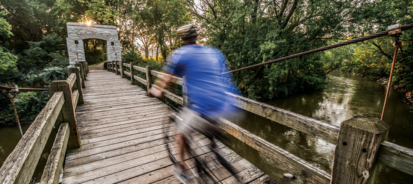 man biking over bridge in Hoyt Park