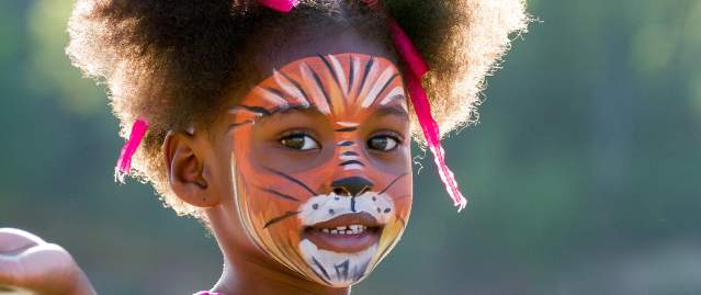 Young girl with face painted at downtown event