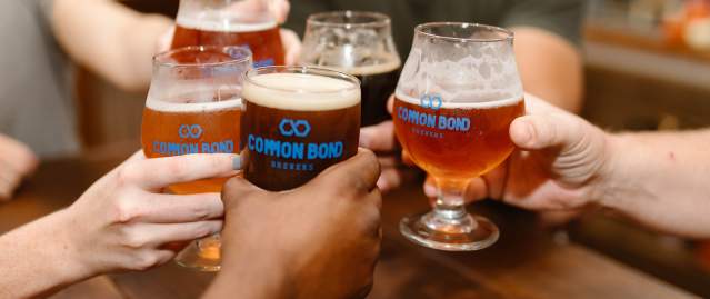 People Cheering with beer at Common Bond Brewers