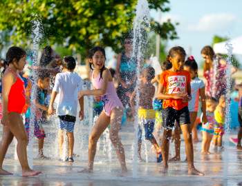 Kids enjoying the splash pad during Food Truck Fridays at the plaza at the Smart Financial Centre at Sugar Land