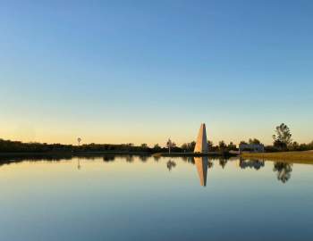 remembrance tower at Sugar Land Memorial park surrounded by a large body of water