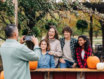 A family posing for a fall photo