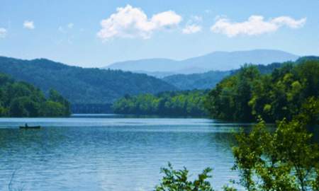 Person in a canoe on Chilhowee Lake in Knoxville, TN