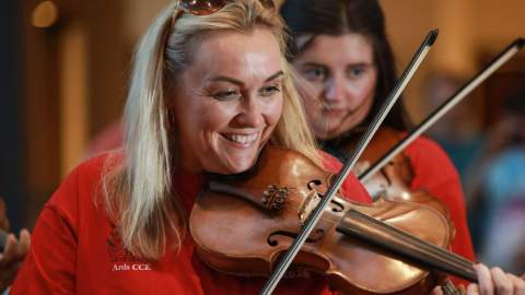 Blonde woman playing the violin