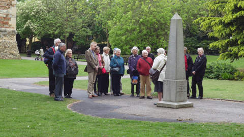 Guided tour group standing next to the Obelisk in Castle Park